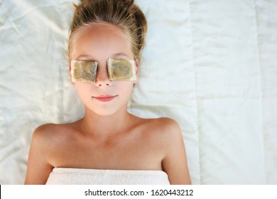 Beautiful Girl With Tea Bags On Eyes. Top View.