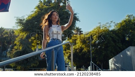 Similar – Brünette Frau, die mit einem Handy einen Fluss fotografiert.