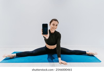 Beautiful girl training in the gym. Russian classic dancer doing stretching and yoga poses - Powered by Shutterstock