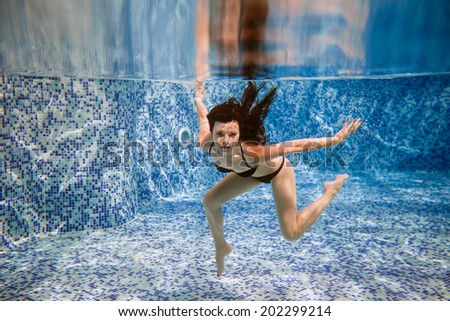 beautiful girl underwater in pool. fashion portrait. pose