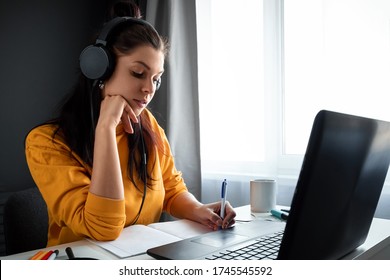 Beautiful Girl Using Laptop Studying At Home, Online Education Concept, Studying Science Behind A Laptop. Watching A Webinar, Looking For Friends On Social Networks. Modern Technologies