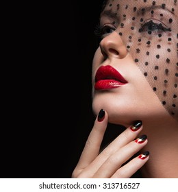 Beautiful girl with a veil, evening makeup, black and red nails. Design manicure. Beauty face.