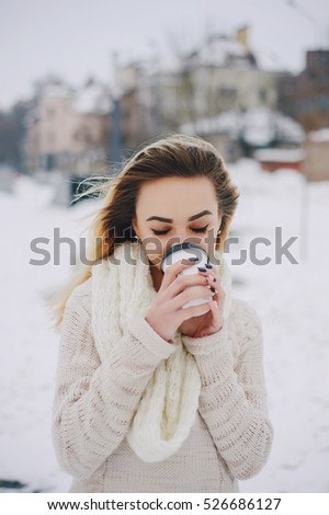 beautiful girl walking in winter park. uses communication