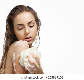 Beautiful girl washing her body shower gel. Isolated on white background.