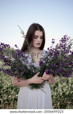 Similar – Woman posing in field of white flowers