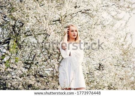 Beautiful girl in a white dress. Woman in a summer park