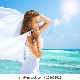 Beautiful Girl With White Scarf on The Beach. Travel and Vacation. - Powered by Shutterstock