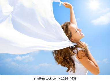 Beautiful Girl With White Scarf over Blue Sky. Freedom Concept