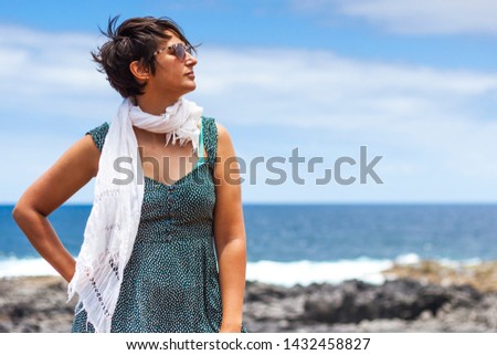 Beautiful girl with white scarf and sunglasses with blue sky