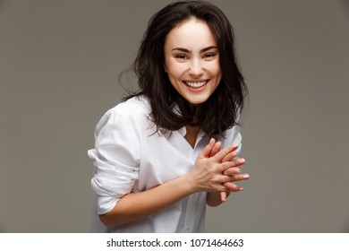 Beautiful girl in a white shirt shows emotions - smile, fun. - Shutterstock ID 1071464663