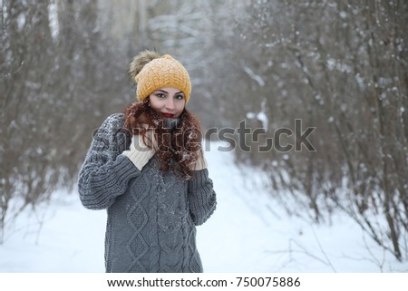 Beautiful girl in a beautiful winter park for a walk 