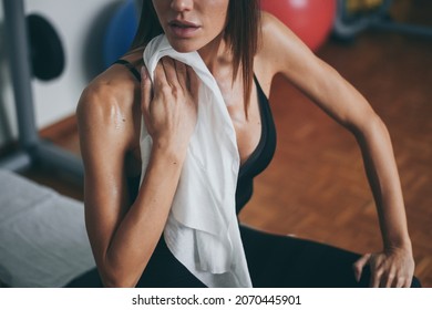 Beautiful Girl Wipes The Sweat After Training Session. Young Sporty Woman At The End Of The Session In The Gym. Sweaty Athlete With Towel Ready To Take Shower. Sport, Health, Youth And Leisure Concept