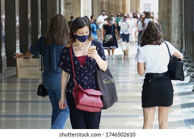 Beautiful Girl Or Woman With Mask Checking The App Stop Covid On The Smartphone In The Street During Covid Or Coronavirus Days, Contact Tracing Or Tracking System. Turin, Italy - June 2020