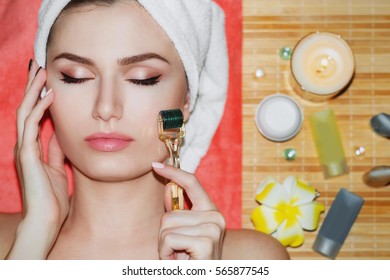 Beautiful girl woman in spa salon,facial rejuvenation procedure.Visit a beautician.Hyaluronic acid rejuvenation beauty injections mesotherapy.Concept of mesotherapy.Cosmetology.Mezoroller,mesotherapy,