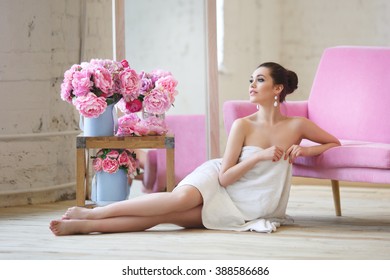 Beautiful girl wrapped in a towel in white and pink intrerere