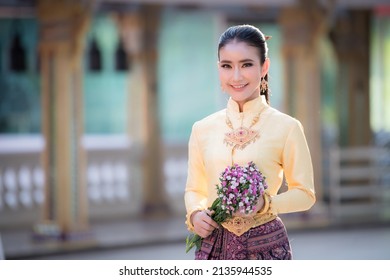 Beautiful girl in yellow Thai dress.Thai girl in retro Thai dress,Beautiful Thai girl in traditional dress costume