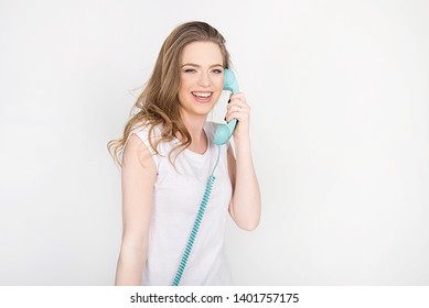 Beautiful Girl, Young Adult, Smiling And Screaming Over The Phone, Holding Blue Land Line Phone Telephone Headset, Horizontal Isolated On White, Blond Model