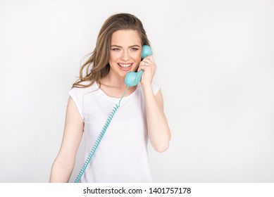 Beautiful Girl, Young Adult, Smiling And Screaming Over The Phone, Holding Blue Land Line Phone Telephone Headset, Horizontal Isolated On White, Blond Model