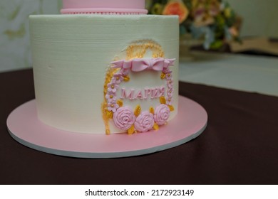 Beautiful girlish birthday cake with pink cream roses, bow, inscription name Maria. One year old or five years old birthday cake, sweet dessert treat