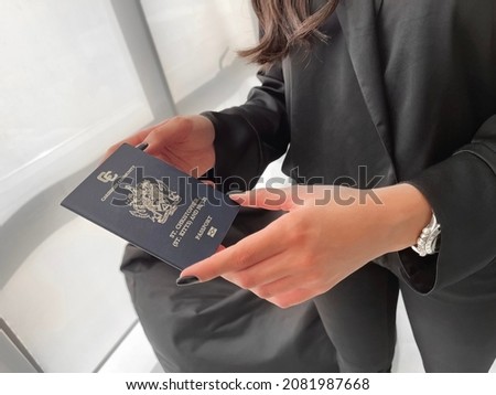 Beautiful girl's hand holding Saint Kitts and Nevis passport