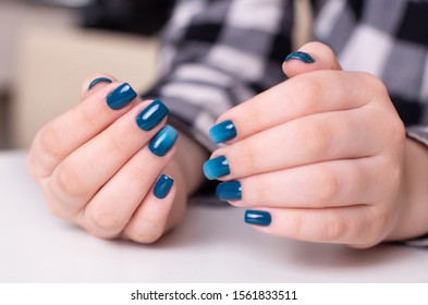 Beautiful girls hands and light blue gradient nails design