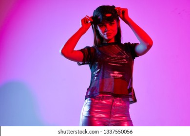 Beautiful Glamor Woman In Silver Lake And In A Transparent T-shirt Purple Disco Party Background