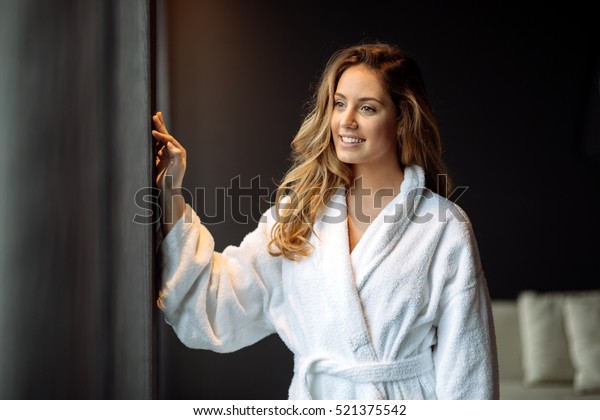 Beautiful glamorous woman in bathrobe enjoying\
wellness weekend
