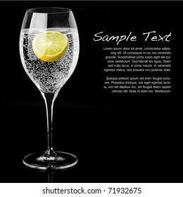 Beautiful Glass With Sparkling Water Or Other Transparent Drink And A Slice Of Lemon On Black Background