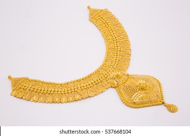Beautiful gold neckless isolated on black background. Gold jewellery stock photo.