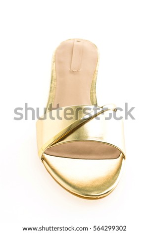 Beautiful gold sandal shoes for woman isolated on white background