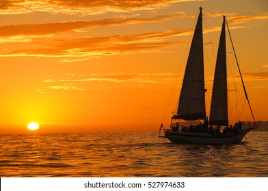 Beautiful gold sunset with a sailboat 