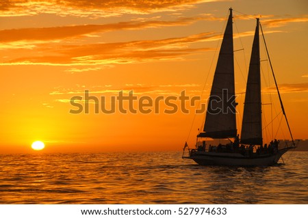 Beautiful gold sunset with a sailboat 