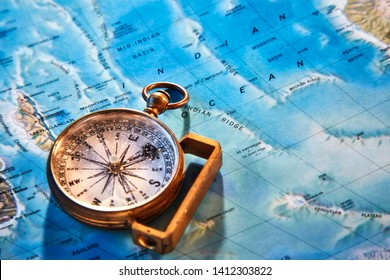 Beautiful golden ancient compass over a map containing Madagascar and a part of the Indian Ocean at the Tropic of Capricorn