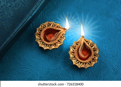 Beautiful Golden Diwali Diya Lamp Lights On Blue Background