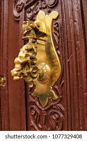 Beautiful Golden Door Knocker With Dog Shape On Old Wooden Door