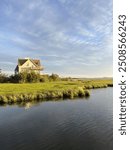 beautiful golden hour light striking house on bay in fenwick island, delaware