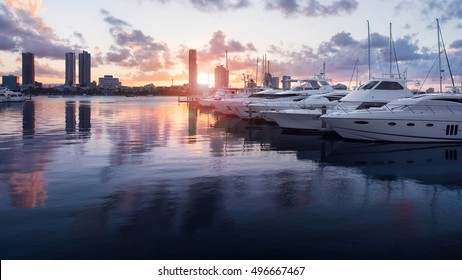 Beautiful Golden Hour Sunset In A Marina With Boats and Yachts Reflecting in the Water and Overlooking Southport, Main Beach, Gold Coast, Queensland, Australia