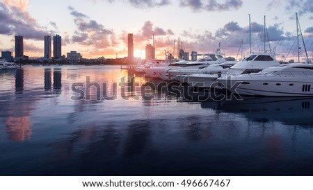 Beautiful Golden Hour Sunset In A Marina With Boats and Yachts Reflecting in the Water and Overlooking Southport, Main Beach, Gold Coast, Queensland, Australia