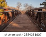 Beautiful golden light of the setting sun on the bridge over the Gooseberry River on a cool November autumn afternoon at Gooseberry Falls State Park in Two Harbors, Minnesota USA.