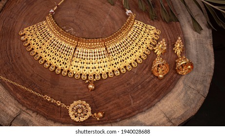 A beautiful golden necklace with stone and diamonds on wooden background. Selective focus