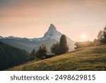 Beautiful golden sunset over Matterhorn mountain with wooden chalet on hill in rural scene at Findeln, Zermatt, Switzerland