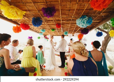 beautiful  gorgeous blonde bride with orchids and stylish groom, hawai colorful ceremony  on cyprus