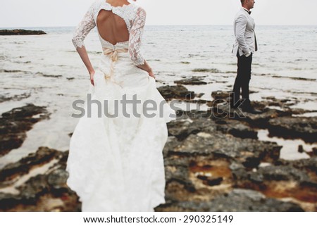 beautiful  gorgeous blonde bride  and stylish groom, on the background of a sea, wedding ceremony  on cyprus