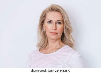 Beautiful Gorgeous Middle Aged 50s Woman Looking At Camera Isolated On White. Mature Elderly Woman Close Up Portrait. Healthy Beauty Face Skin Care, Middle Age Skin Care Cosmetics, Cosmetology Concept