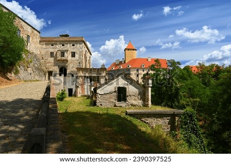 Beautiful Gothic castle Veveri. The city of Brno at the Brno dam. South Moravia - Czech Republic - Central Europe. Landscape with castle, forest, sky and clouds and sun in the sky. 