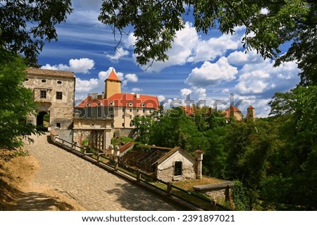 Beautiful Gothic castle Veveri. The city of Brno at the Brno dam. South Moravia - Czech Republic - Central Europe. Landscape with castle, forest, sky and clouds and sun in the sky. 