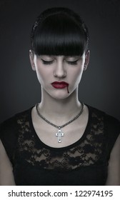 Beautiful gothic vampire woman portrait over dark background
