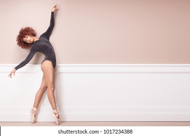 Beautiful graceful ballerine with afro hairstyle dancing. Ballet class training.
