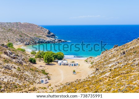 Beautiful greek summer sunny beach bay view to mediterranean blue sea awesome turquoise water like paradise with small white house village, Psili Ammos Beach, Patmos Island, Kos, Dodecanese, Greece