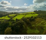 Beautiful green fields and farmland are bathed in sunshine in the scenic, rolling hills of ireland